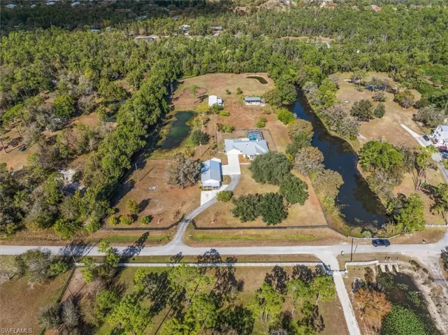 Aerial view of property and surrounding area featuring a large body of water