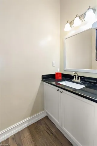 Bathroom featuring vanity and dark wood-style floors