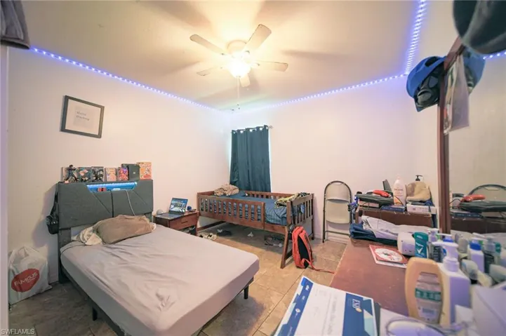 Tiled bedroom with ceiling fan