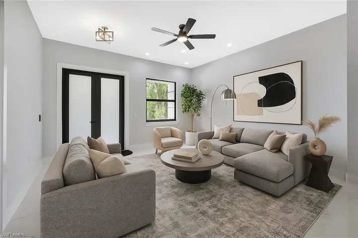 Living area with a ceiling fan, recessed lighting, and french doors