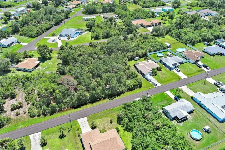 Aerial perspective of suburban area featuring a tree filled landscape