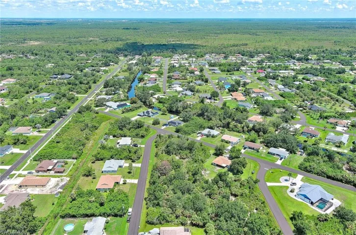 Aerial overview of property's location featuring nearby suburban area