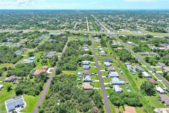 Aerial overview of property's location featuring nearby suburban area