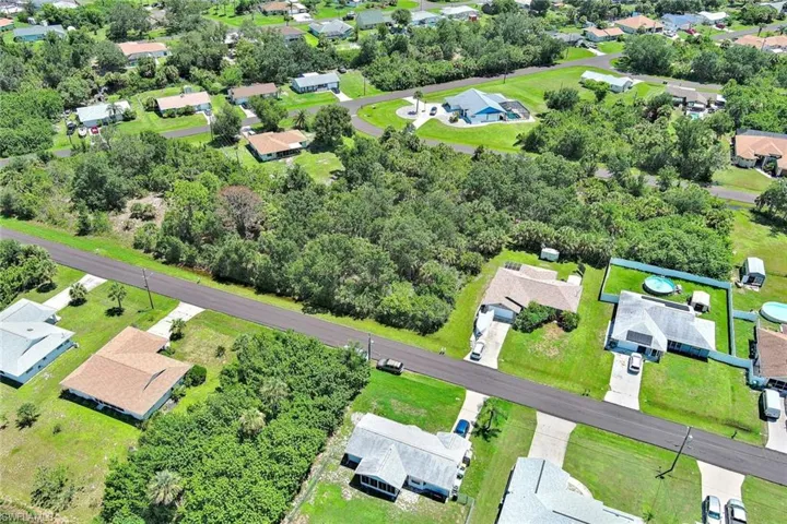 Aerial perspective of suburban area with a tree filled landscape