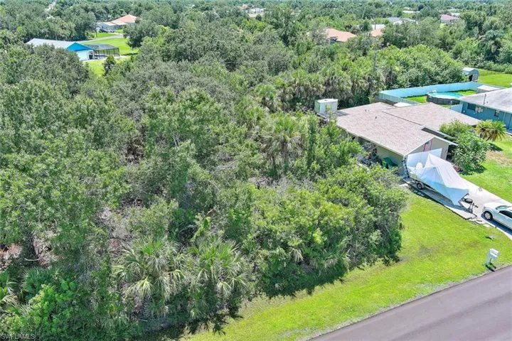 View from above of property featuring a heavily wooded area