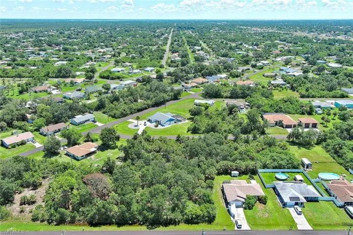 Aerial perspective of suburban area with a tree filled landscape
