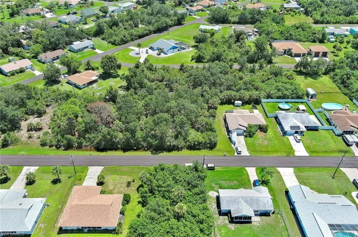 Aerial perspective of suburban area featuring a tree filled landscape
