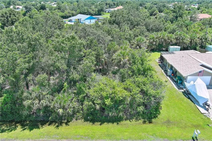 View of subject property featuring a forest