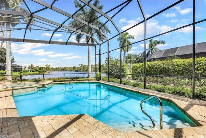 View of pool with a water view and a lanai