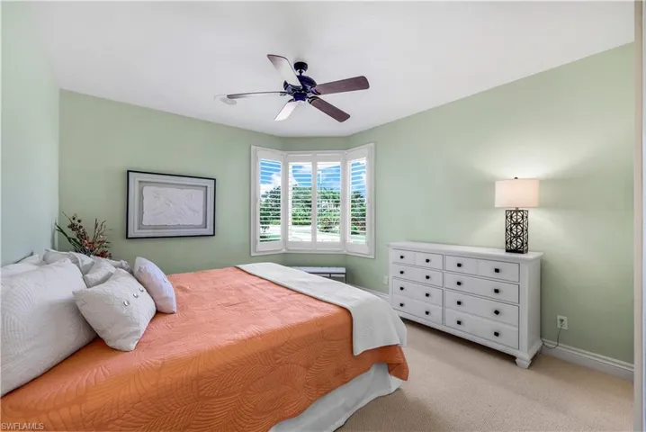 Bedroom featuring ceiling fan and light colored carpet