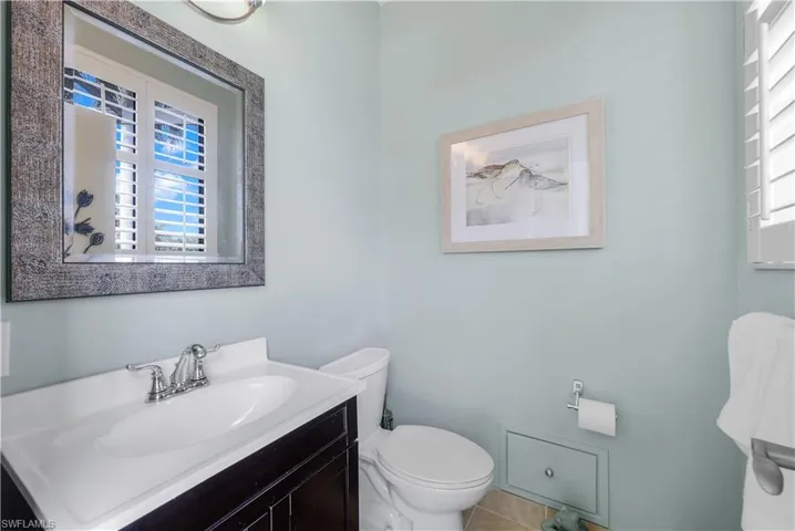 Bathroom with tile patterned floors, vanity, and toilet