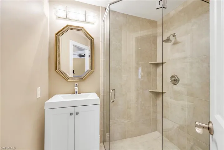 Bathroom with vanity and an enclosed shower