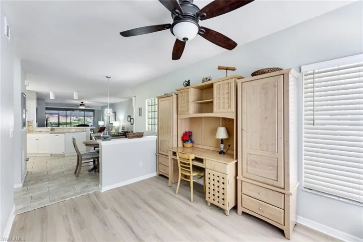 Office area featuring a ceiling fan, light wood-type flooring, and built in study area
