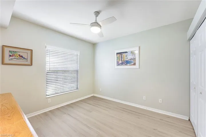 Unfurnished bedroom with a closet, light wood-style flooring, and a ceiling fan