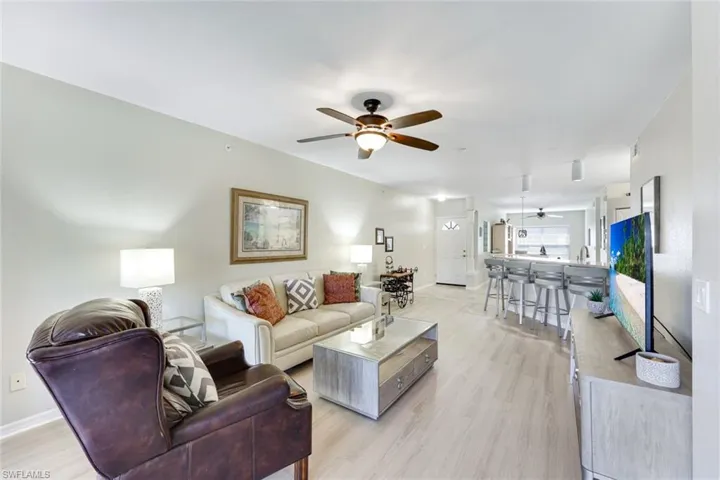 Living area featuring ceiling fan and light wood-style flooring