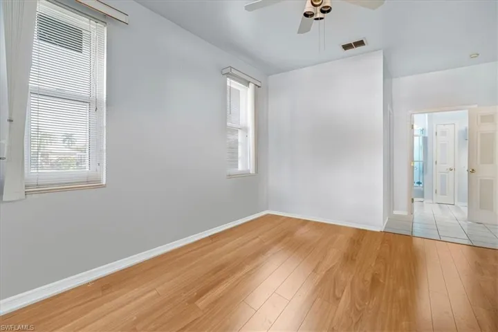 Empty room featuring ceiling fan and light hardwood / wood-style floors