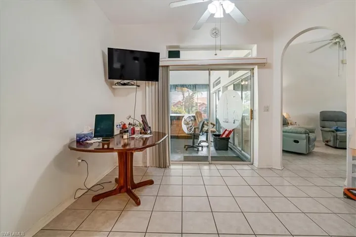 Tiled office space featuring ceiling fan