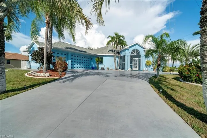 Ranch-style home featuring a front yard and a garage