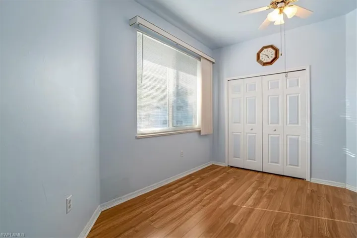 Unfurnished bedroom featuring ceiling fan, light hardwood / wood-style flooring, and a closet