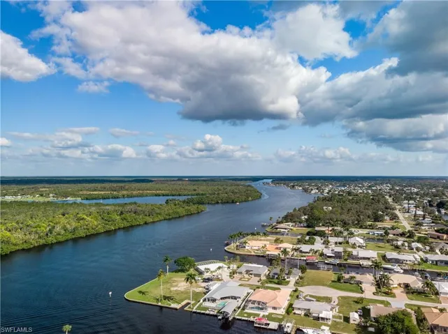 Drone / aerial view with a water view and a residential view