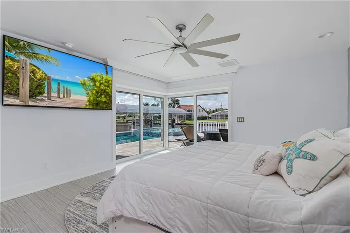Bedroom with visible vents, ceiling fan, access to outside, and baseboards