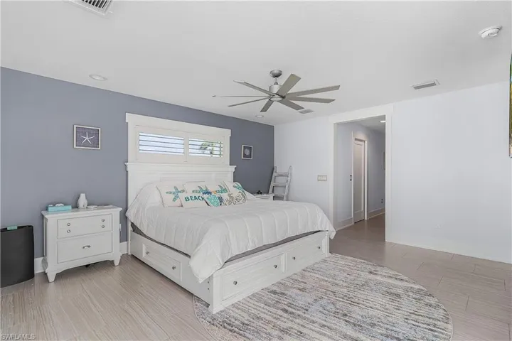 Bedroom featuring baseboards, visible vents, and a ceiling fan