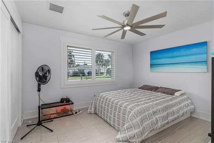 Bedroom featuring a closet, visible vents, ceiling fan, and baseboards