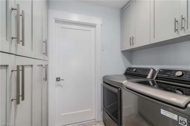 Laundry room featuring cabinet space and washing machine and clothes dryer