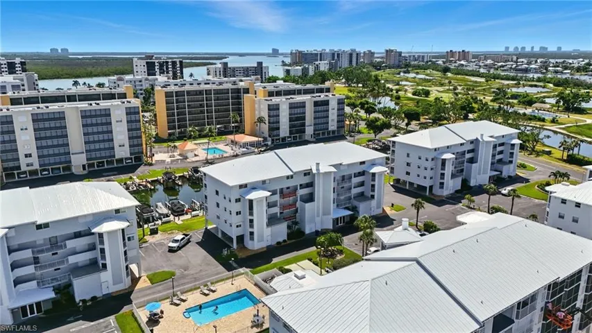 View of urban area featuring a nearby body of water and a pool - Virtually Edited Image