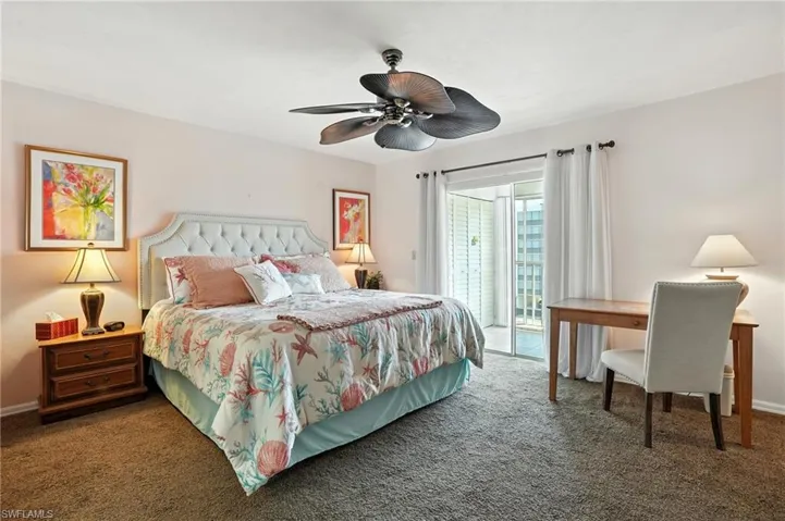 Carpeted bedroom featuring access to exterior and a ceiling fan - Virtually Edited Image