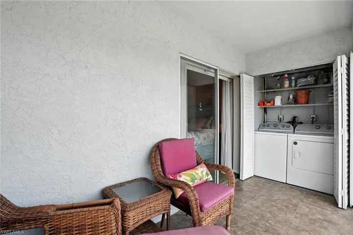 Laundry area with a textured wall and separate washer and dryer - Virtually Edited Image