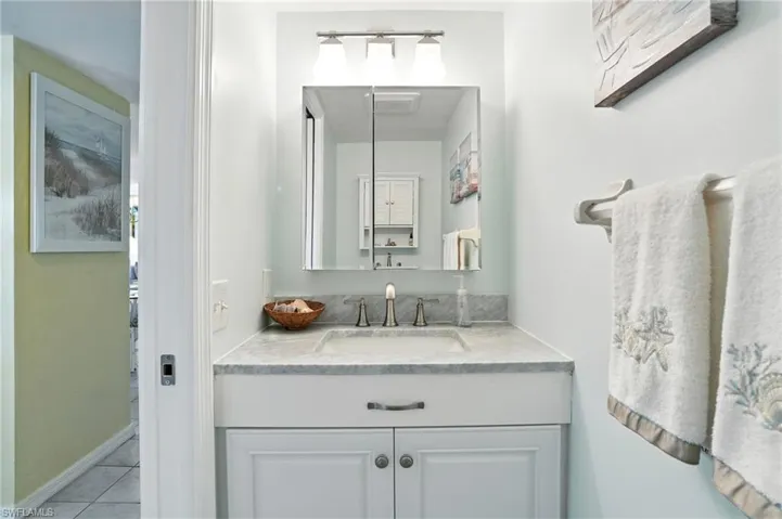 Bathroom featuring vanity and tile patterned floors - Virtually Edited Image