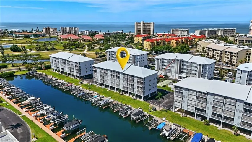 View of urban area featuring a large body of water and a marina - Virtually Edited Image