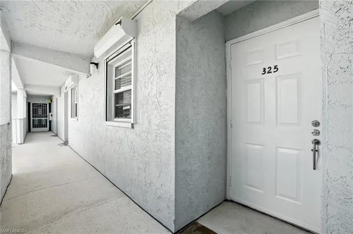 View of exterior entry featuring stucco siding - Virtually Edited Image