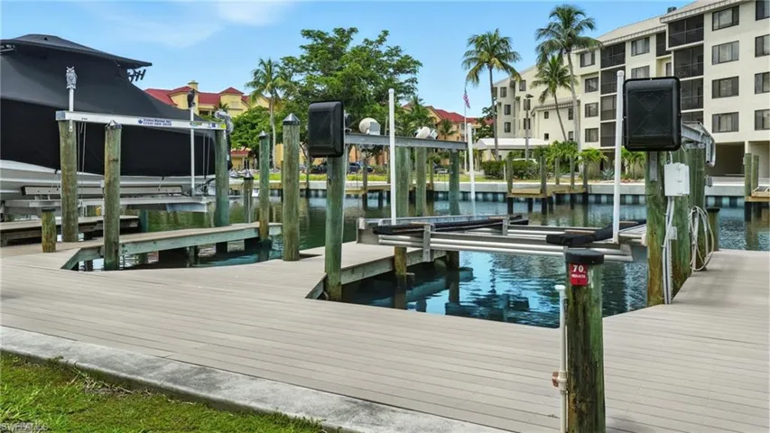 Dock featuring boat lift and a water view - Virtually Edited Image