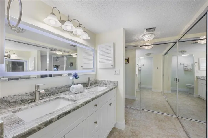 Mirrored Closets, Medicine Cabinets, Tile Floor, Separate Step In Glass Shower and Water Closet (not shown)- Privacy Pocket Door