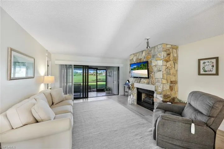 Large Sofa, Relaxing Recliner, Soft Area Rug, New Window Treatments- New Hurricane Rated Slider to Lanai