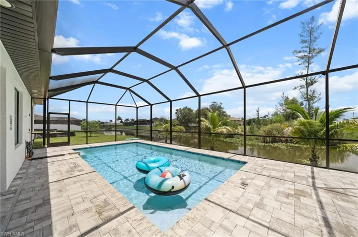 Swimming pool featuring a patio area and a lanai