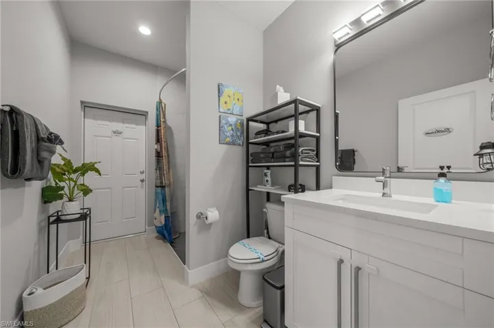 Full bathroom with vanity and curtained shower