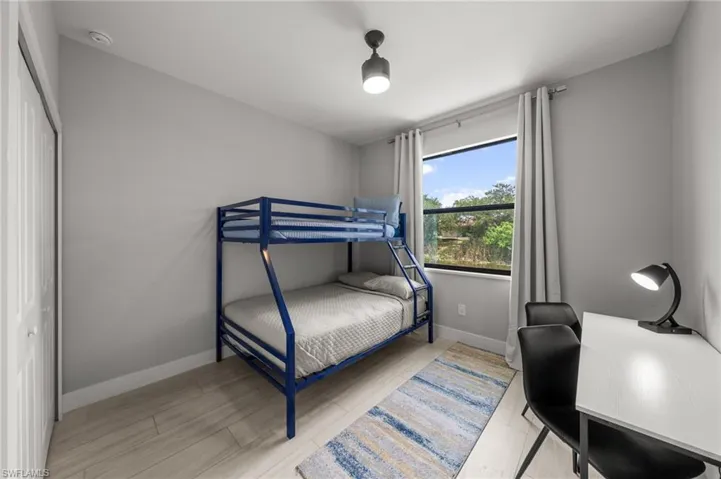 Bedroom featuring baseboards and wood finished floors