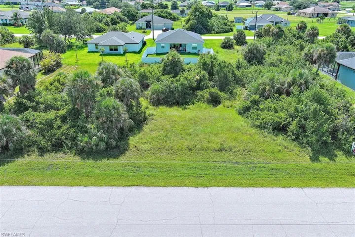 Aerial perspective of suburban area featuring a tree filled landscape