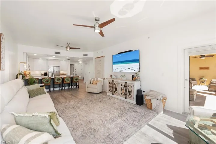 Living room featuring ceiling fan and light wood-style floors