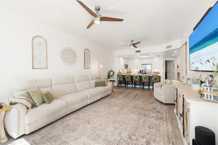 Living area with light wood-style flooring and a ceiling fan