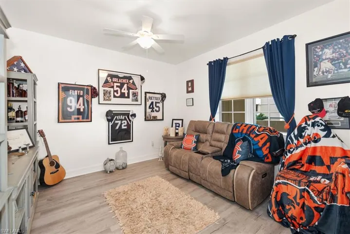 Living area with light wood-style flooring and ceiling fan