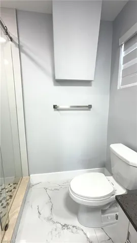 Full bath 3 with a shower stall, marble finish floors, and vanity