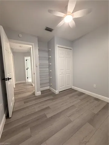 Unfurnished bedroom 2 featuring ceiling fan, light wood-style flooring, and a closet