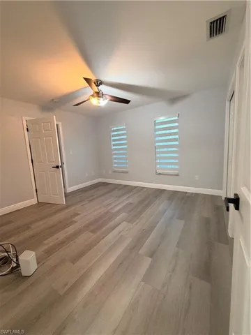 Room 3 Unfurnished bedroom with light wood-style flooring and a ceiling fan