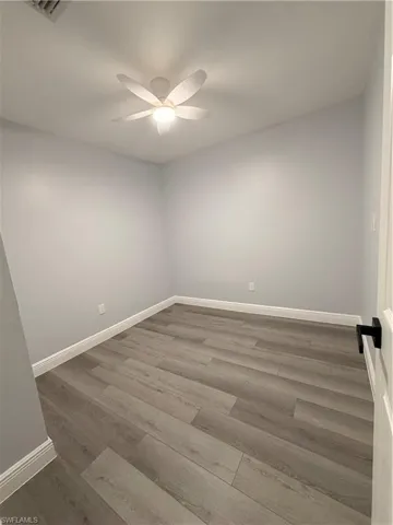 Empty room 1 featuring light wood-style flooring and ceiling fan