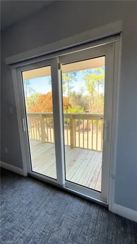Doorway to outside Master Valcony featuring baseboards and carpet floors