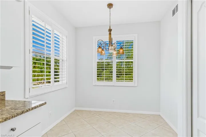 Start your day in this bright and inviting breakfast nook, the perfect spot to enjoy your morning coffee while taking in peaceful views and abundant natural light.